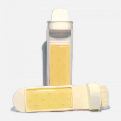 A set of R2A dipslides, which are used for dental hygiene and water testing, displayed with a transparent lid and a flexible paddle. One dip slide is shown with a yellow agar block, and the other is without the agar block, exposing the white supportive structure.